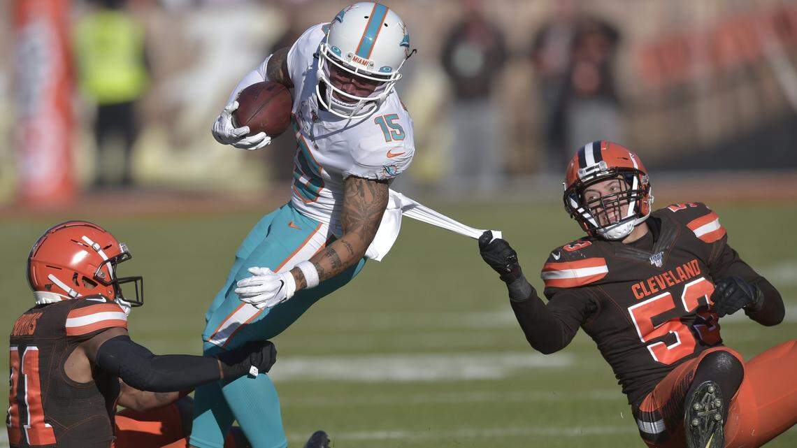 Miami Dolphins wide receiver Albert Wilson (15) tackled by Cleveland Browns safety Juston Burris (31) and middle linebacker Joe Schobert (53) during the first half of Sunday’s game.