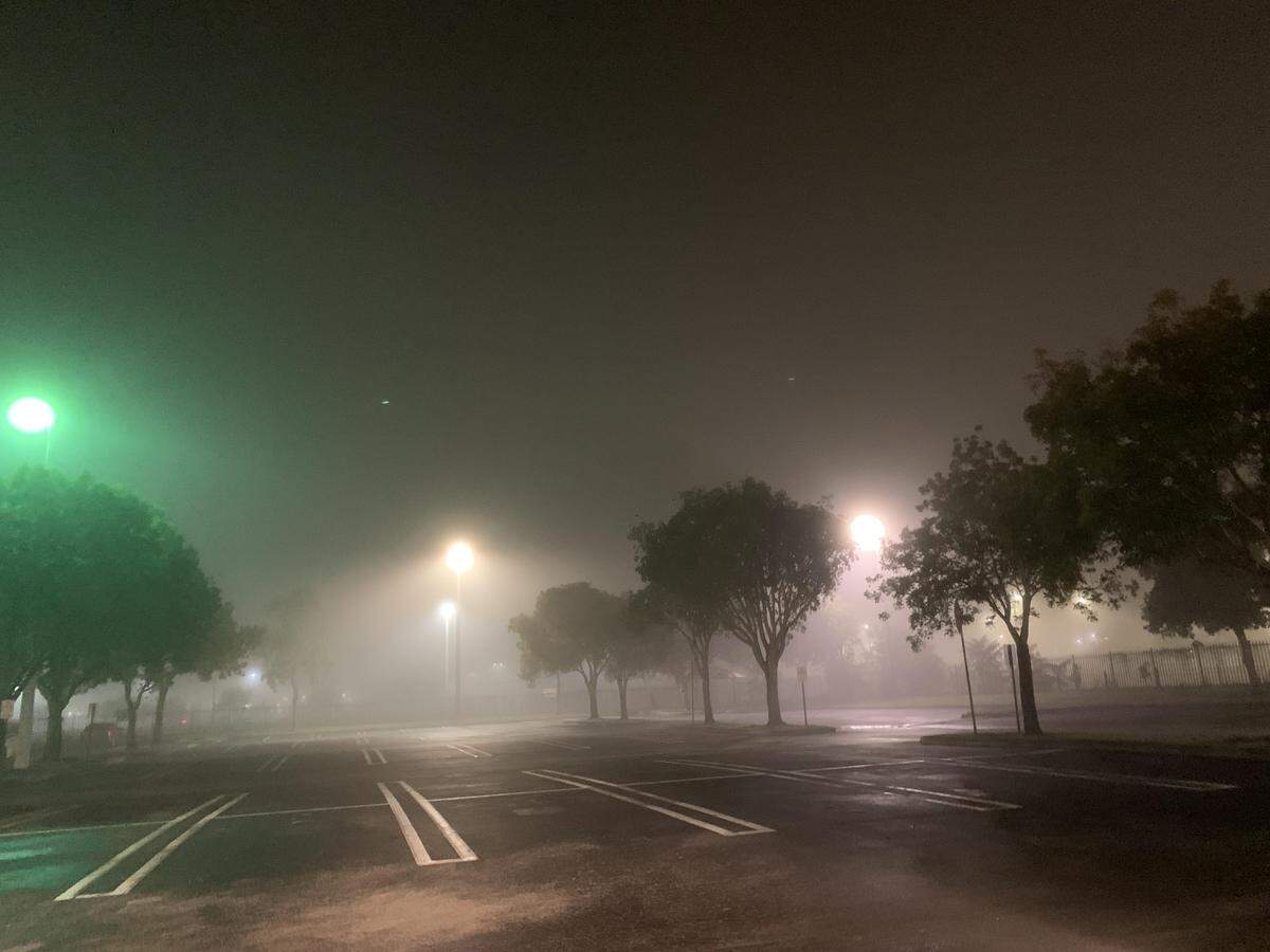 Dense fog stretches across a parking lot early Tuesday.