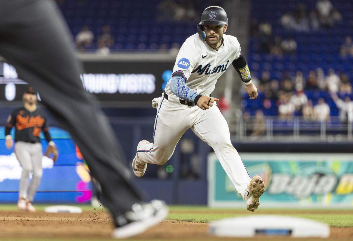 Miami Marlins catcher Joe Mack (80) runs toward third base after third baseman Javier Sanoja (8) hit a single against the Baltimore Orioles in the ninth inning of their MLB game at loanDepot park on Thursday, May 7, 2026, in Miami, Fla.