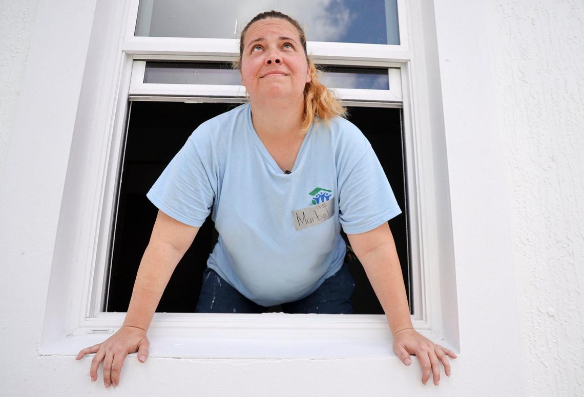 Maribel Gonzalez, 41, looks out the window of her new Habitat for Humanity of Greater Miami home in South Miami-Dade’s Goulds neighborhood. Gonzalez and seven other new soon-to-be homeowners are helping hammer together their houses during Habitat’s annual Blitz Build. The nonprofit recently marked 30 years in operation.