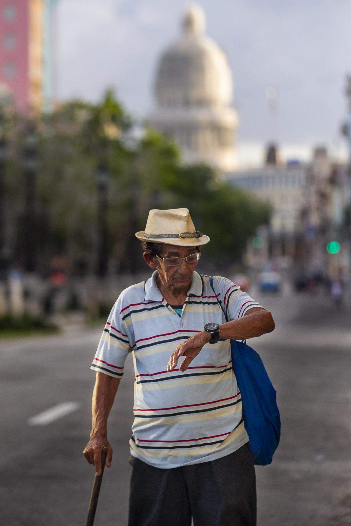 A man checks the time along the Paseo de Martí in Havana, Cuba.