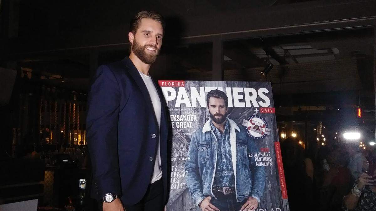 Florida Panthers defenseman Aaron Ekblad poses with a replica of the cover of the Panthers’ 25th anniversary commemorative magazine at the Boatyard in Fort Lauderdale.