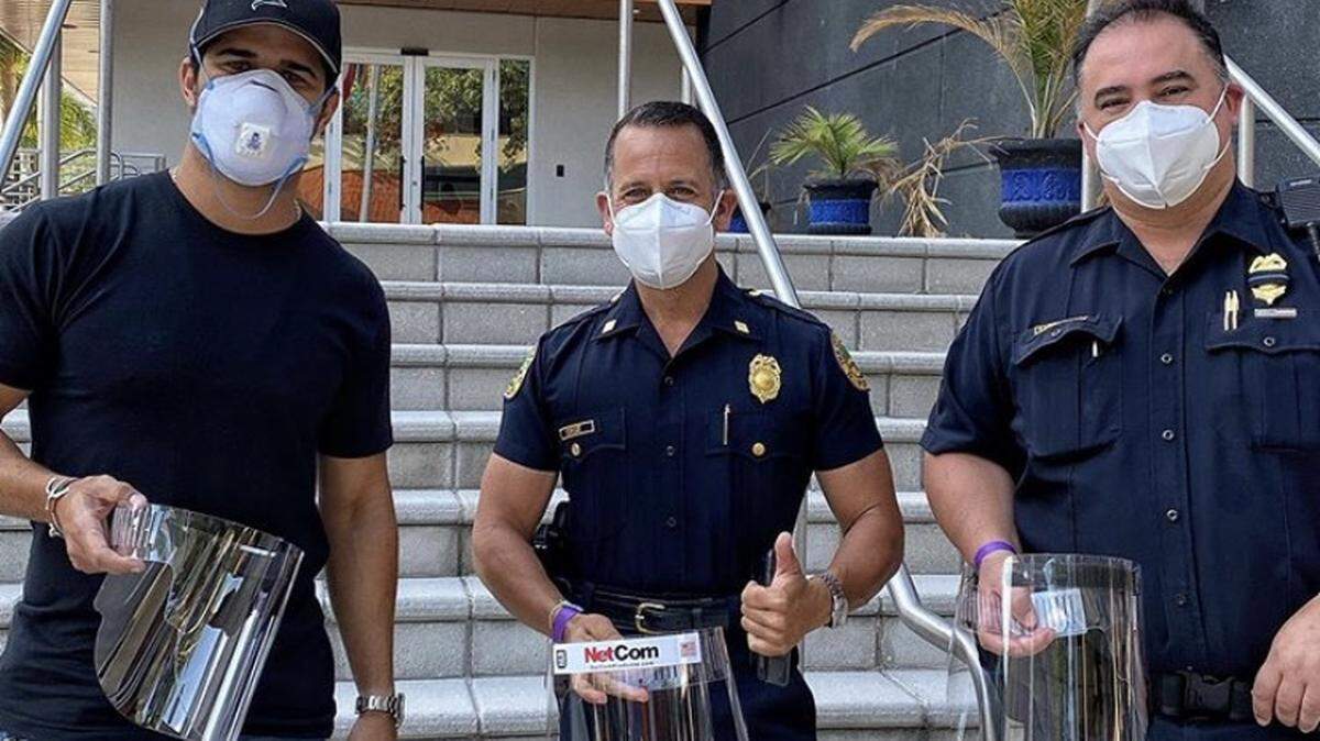 Gulliver alum Alex Mijares, CEO of NetcomProducts, and his manufacturing team have produced PPE face shields and donated thousands of them to hospitals, police officers and essential workers. From left, Mijares, Miami Police Commander Freddy Cruz and Miami Police Sgt. Walter Sarrafiore.