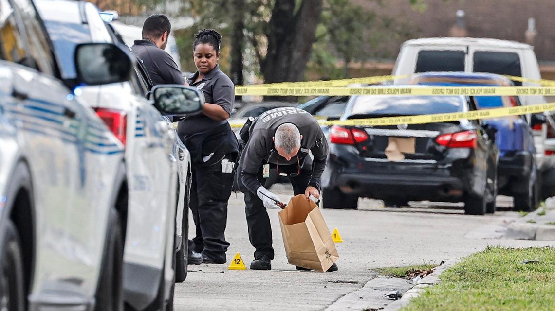 Miami police crime scene investigators gather evidence at the scene of a residence near Northwest Seventh Court and 58th Street in Miami, Florida on Thursday, March 7, 2024., after Miami police shot a man standing on a porch multiple times.