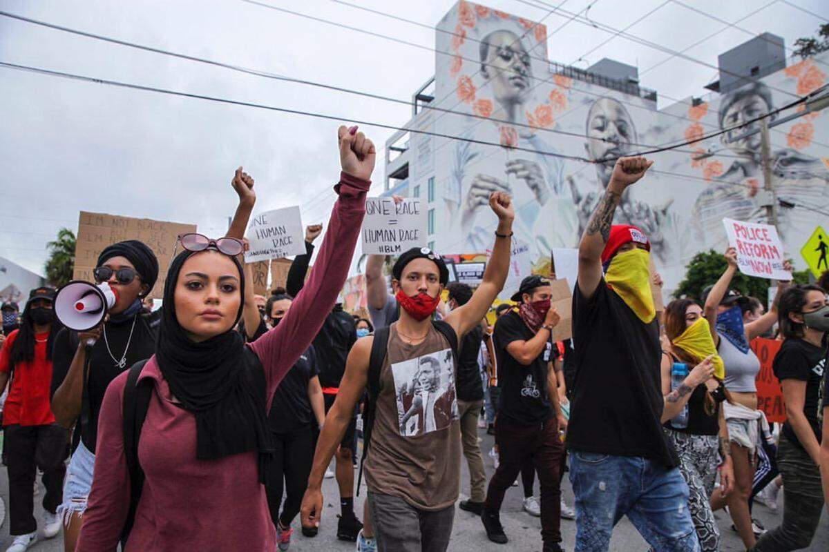 Alaa Massri, far left, was arrested June 10 at a Black Lives Matter rally that turned chaotic when demonstrators vandalized a statue of Christopher Columbus. Massri’s hijab was removed for a mugshot, says a petition filed for her on Change.org.