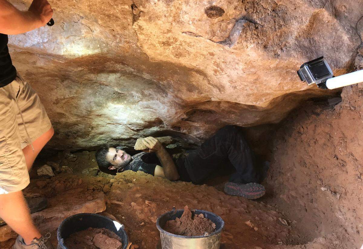 Researchers digging into the sealed passageway.