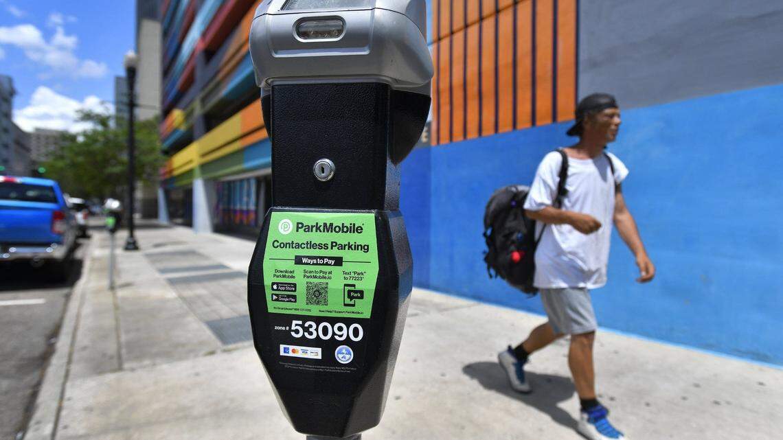 Bright green stickers indicate the downtown parking meters on Julia Street that are set up to use the ParkMobile payment app Tuesday, April 26, 2022. The City of Jacksonville has implemented a contactless payment system for metered parking on the streets of downtown. In addition to using cash or credit cards in the meters, the ParkMobile app allows drivers to use their phones to make payments and extend time remotely. The system went live on Monday. [Bob Self/Florida Times-Union]

Jki 042622 Parkmobile 01