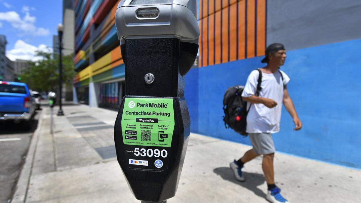 Bright green stickers indicate the downtown parking meters on Julia Street that are set up to use the ParkMobile payment app Tuesday, April 26, 2022. The City of Jacksonville has implemented a contactless payment system for metered parking on the streets of downtown. In addition to using cash or credit cards in the meters, the ParkMobile app allows drivers to use their phones to make payments and extend time remotely. The system went live on Monday. [Bob Self/Florida Times-Union]

Jki 042622 Parkmobile 01