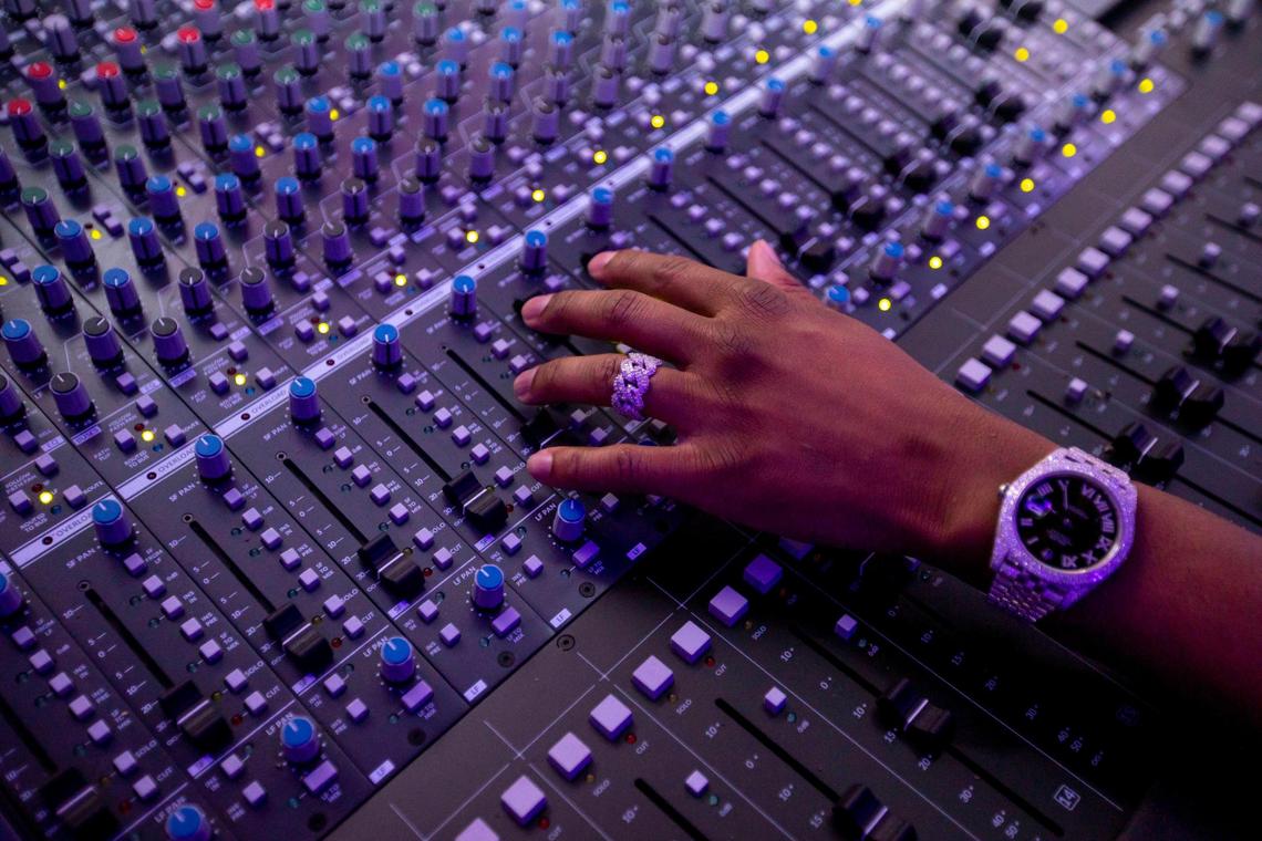 Producer ATL Jacob manipulates a mixing board at a recording studio in Miami, Florida, on Wednesday, Sept. 7, 2022.