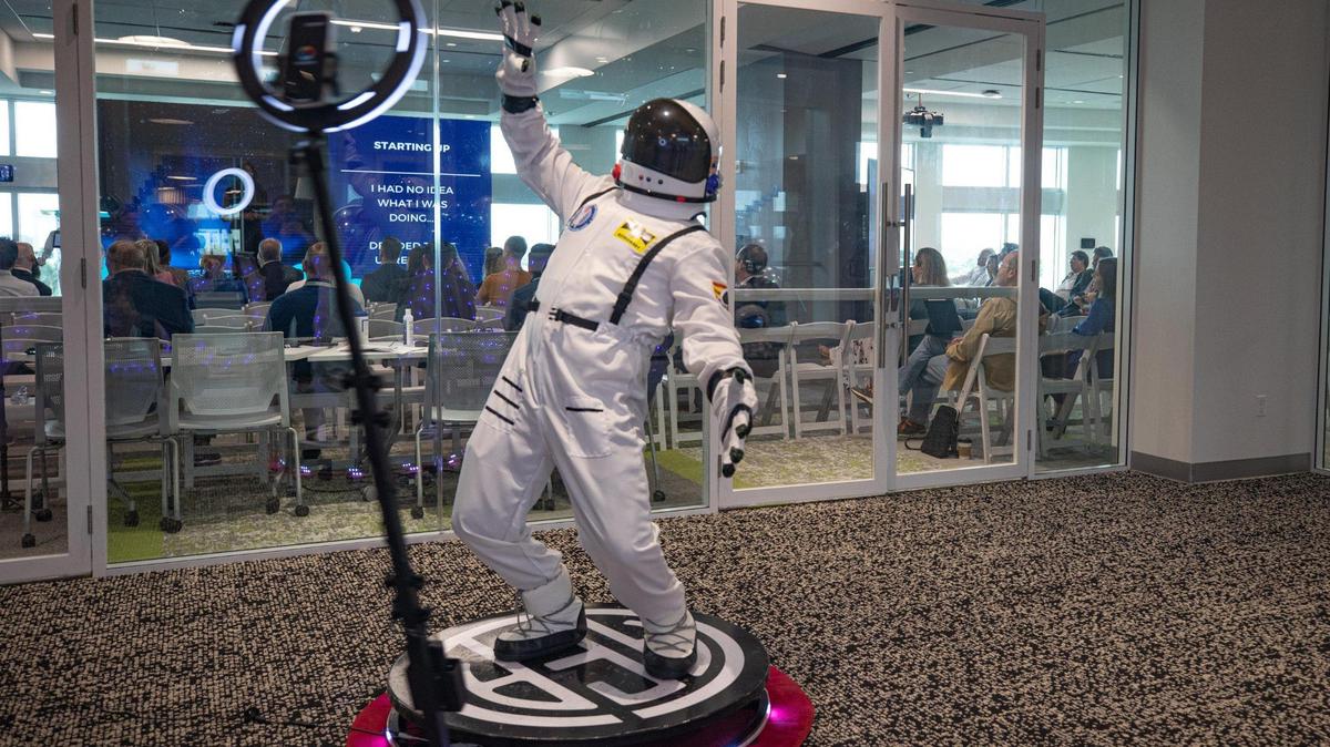 A person dressed as an astronaut uses the photo booth during South Florida Space Day at Nova Southeastern University in Fort Lauderdale on Oct. 12, 2022.