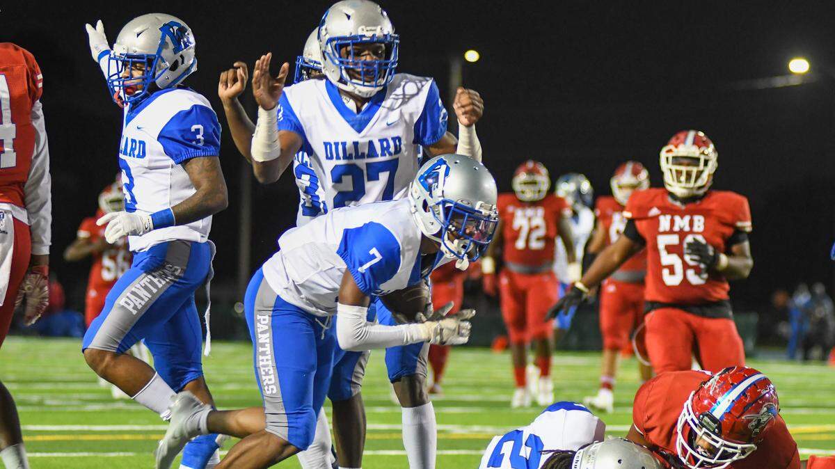 Dillard players celebrate after defensive back D’mon Brinson (7) recovers a fumble against North Miami Beach on Thursday, Dec. 17, 2020, at Traz Powell Stadium.