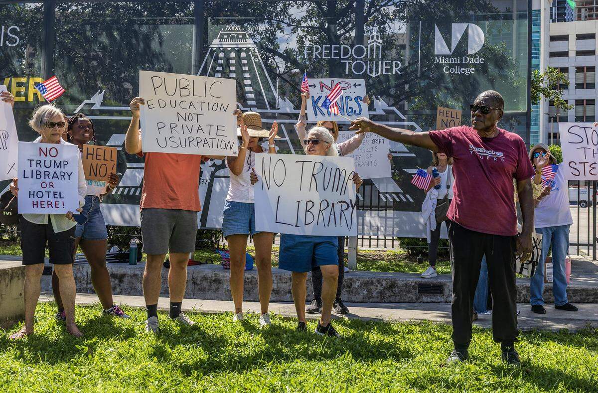 Retired Prof. Marvin A Dunn (right) leads a group of people during a protest next to the Freedom Tower, against giving Miami Dade College property to be used for the Trump presidential library on Monday September 29, 2025.