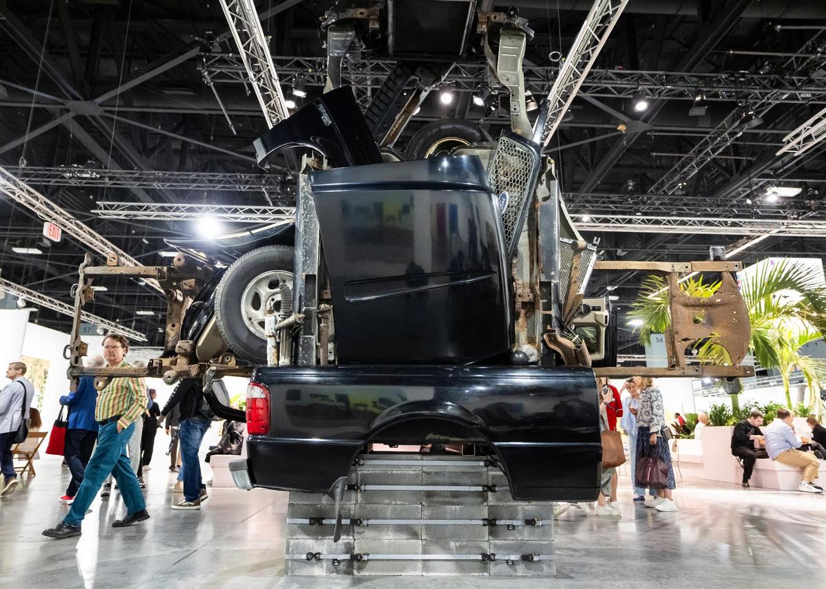People make their way past ‘Untitled’ by Virginia Overton, which is presented by Bortolami, during Art Basel at the Miami Beach Convention Center on Wednesday, Dec. 4, 2024, in Miami Beach, Fla.