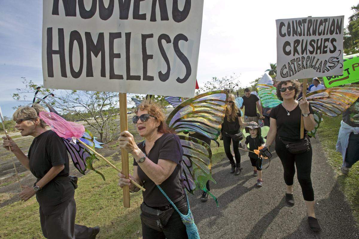 Amy Werba, at center, marches with others as the Miami Rocklands Preservation Coalition and other groups rally to protest a Walmart and an amusement park planned for protected pine rockland near Zoo Miami on Saturday, January 17, 2015.