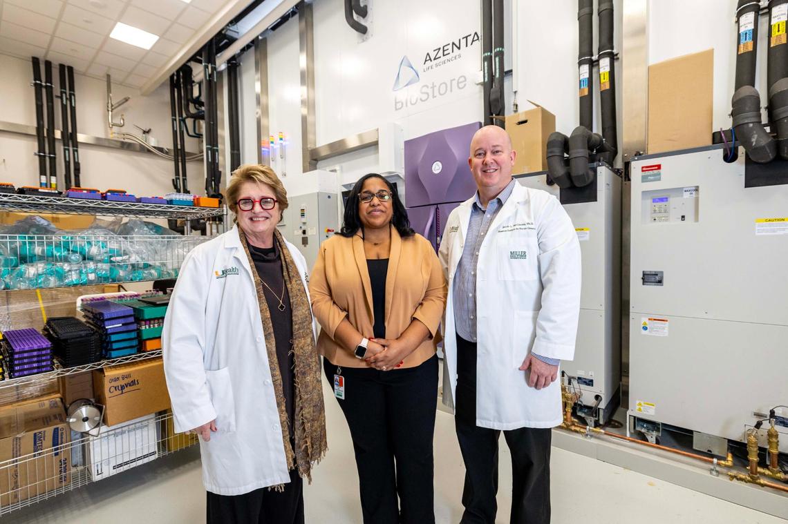 From left to right, Margaret Pericak-Vance, Ph.D, Patrice Whitehead and Jacob McCauley, PH.D, stand beside the Azenta Life Sciences BioStore Ultra High Density -80°C Sample Storage System at the John P. Hussman Institute for Human Genomics on UHealth’s campus on Thursday, January 16, 2025, in Miami, Fla.