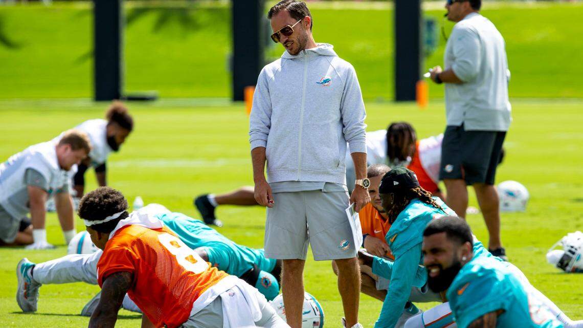 Miami Dolphins Head coach Mike McDaniel speaks with a player during the second day of mandatory mini camp at Baptist Health Training Complex in Miami Gardens, Florida, on Thursday, June 2, 2022.