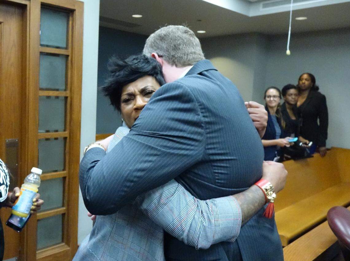 Ann Maynard, who was shot in the head along with her sister and nephew and niece, embraces prosecutor Christopher Flanagan in court. A jury on Thursday convicted the gunman, Jose Estache, for the mass shooting at a child’s birthday party in October 2006.