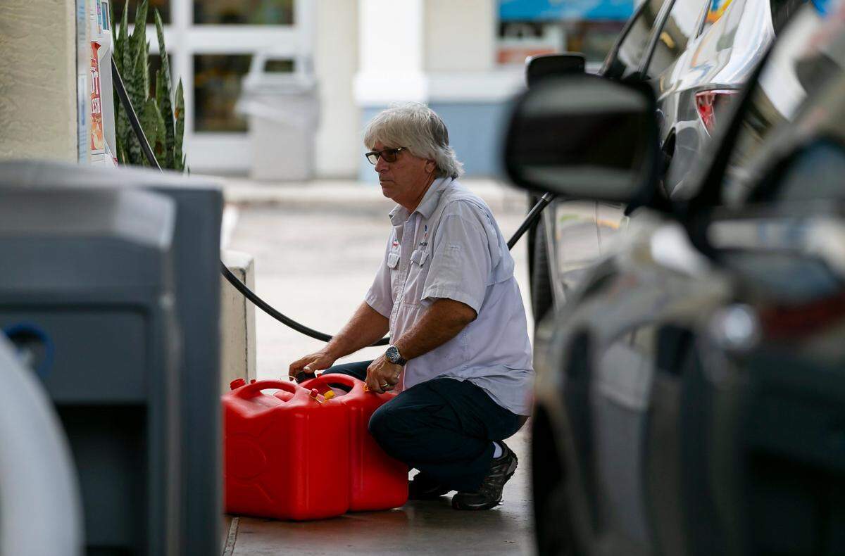 In this file photo, a man fills gas tanks at a Shell station on Saturday, Sept. 24, 2022, in Miramar. 