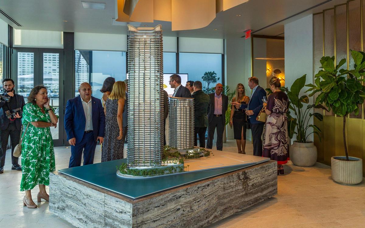 Guests at the Mandarin gala check the model of the new buildings at the Mandarin Residences sales center on May 15, 2025. The hotel is closing at the end of May and will be demolished next year.