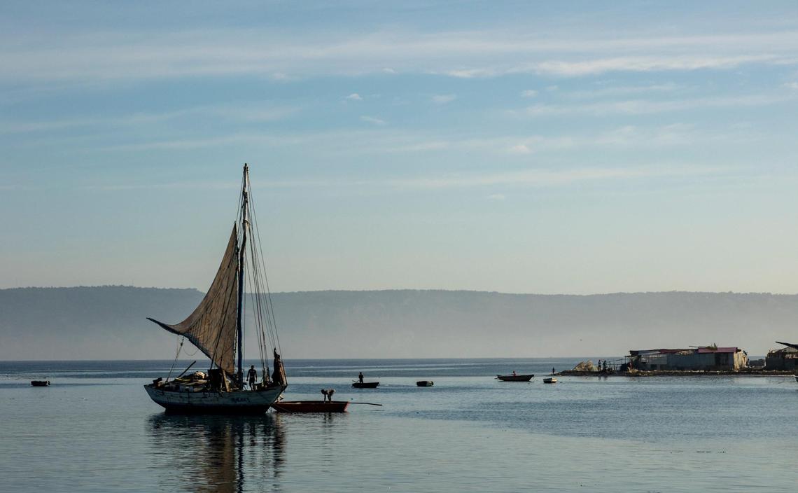 A Haitian sailboat with hand-sewn sails prepares to leave after being loaded with merchandise at the port of Port-de-Paix on March 26, 2022.