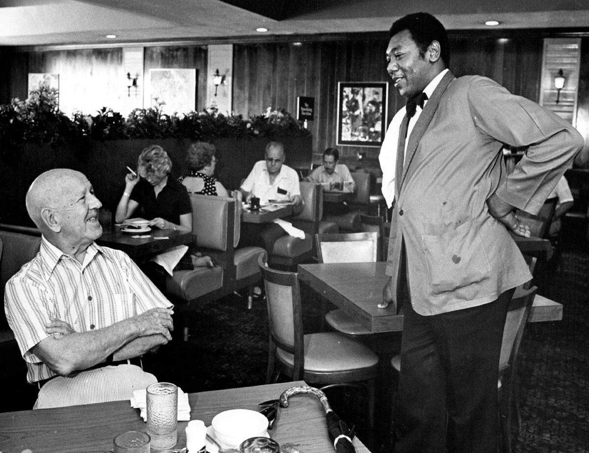 Customers chat with a server at Biscayne Cafeteria.