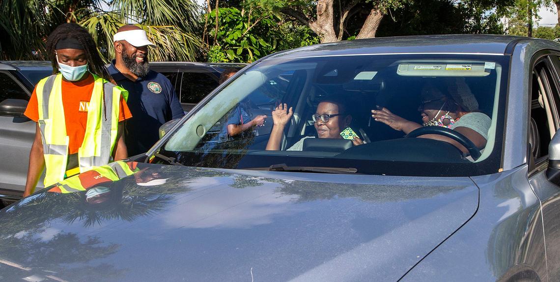 City of North Miami Beach employee Quance Arnette, left, and Democratic state Rep. Christopher Benjamin handed out Publix gift cards to residents lining up in cars at Uleta Park Community Center on Saturday, June 5, 2021.