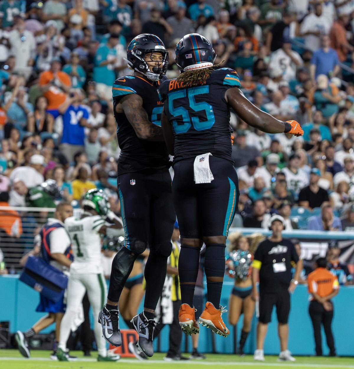 Miami Dolphins tight end Darren Waller (83) celebrates with center Aaron Brewer (55) after scoring his second touchdown against the New York Jets during the second half of an NFL game at Hard Rock Stadium on Monday, Sept. 29, 2025, in Miami Gardens, Fla.
