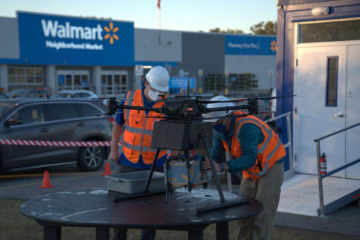 Walmart employees prepare a DroneUp drone to make a delivery to a customer’s home in this new delivery service launched in 2022.