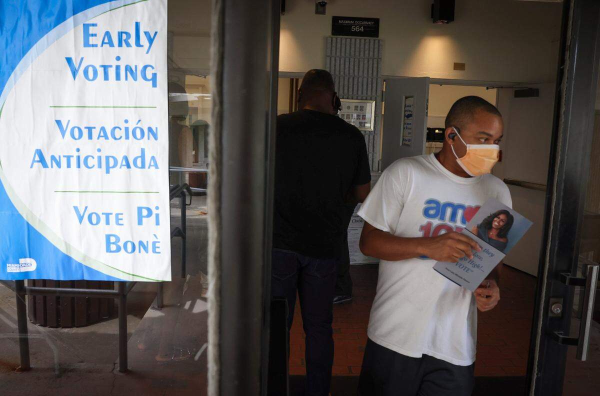 People walk out after voting during the last day of Early Voting on Sunday, Aug. 18, 2024, at the Jospeh Caleb Center in Miami. The poll worker said that this has been their busiest day of early voting.