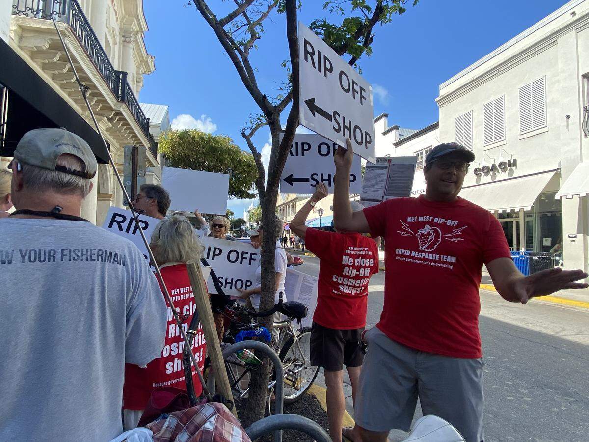 Key West Rip Off Rapid Response Team volunteers protest a cosmetic shop at 518 Duval St., on Feb. 18, 2020. The group says the shops gouge customers.