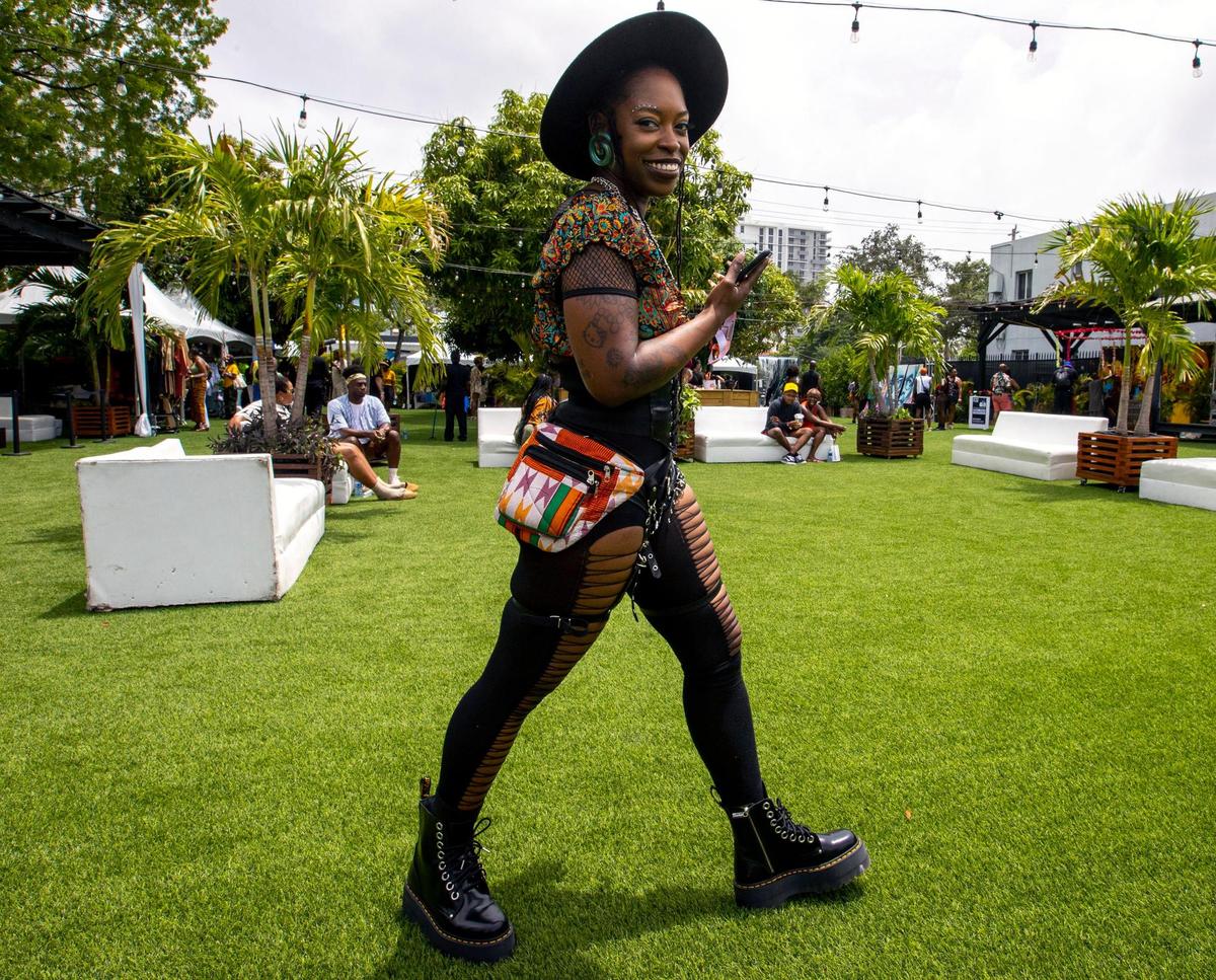 Philadelphia native and South Florida resident of 10 years, Sharelle Hall, 35, walks the event grounds during AFROPUNK music festival at The Urban in the Historic Overtown neighborhood of Miami, Florida, on Saturday, May 21, 2022.
