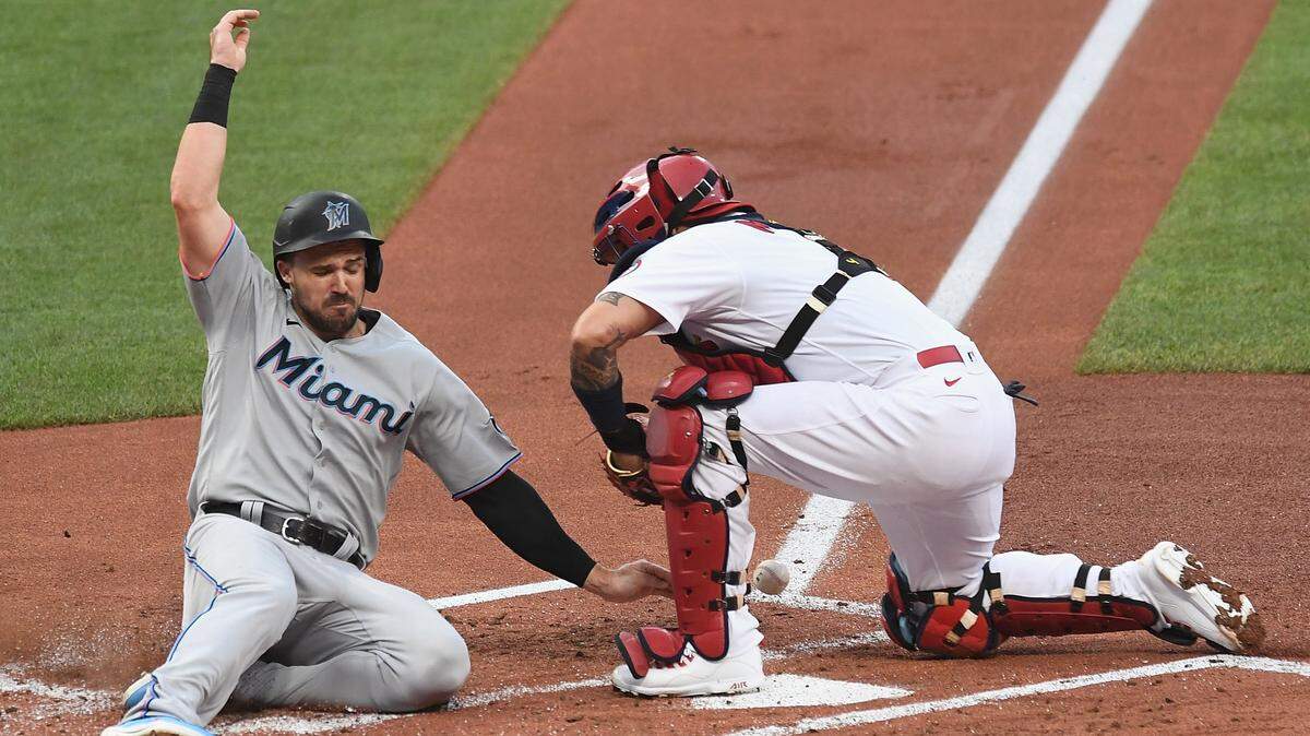 Adam Duvall #14 of the Miami Marlins slides into home base in the second inning against the St. Louis Cardinals at Busch Stadium on June 14, 2021 in St Louis, Missouri. Duvall was later called out after an umpire review.