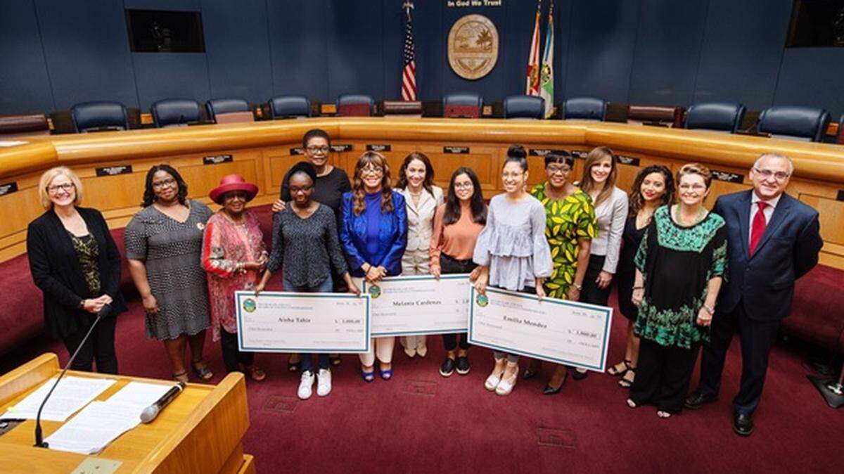 The Miami-Dade County Commission for Women recently awarded three scholarships to graduates at the Young Women’s Preparatory Academy in Little Havana. Pictured above with the winners, from left to right, are County Commission Chairwoman Audrey Edmonson, Vice Chairwoman Rebeca Sosa, Commissioner Eileen Higgins, Commissioner Esteban Bovo, Jr., and members of the commission