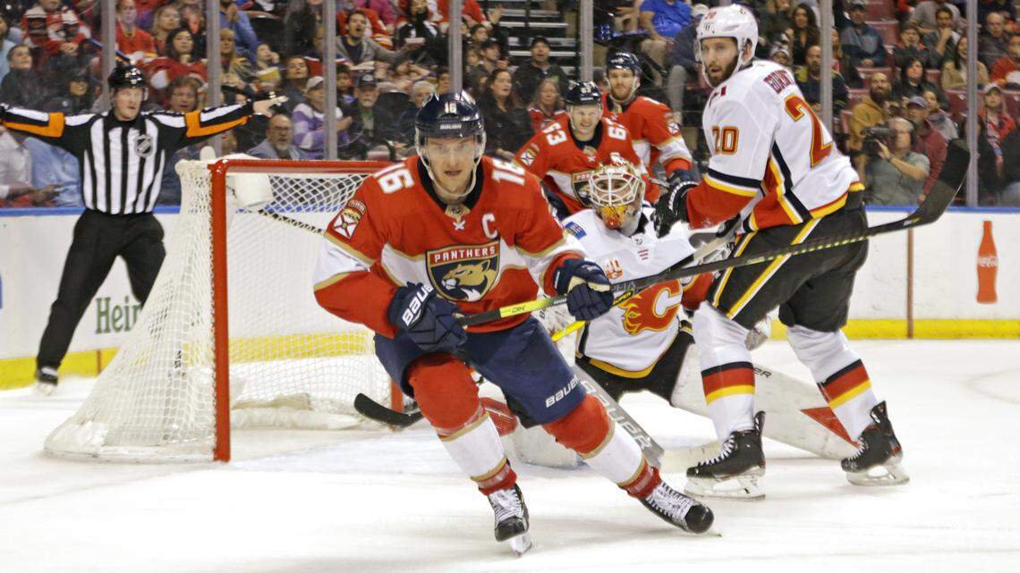 Calgary Flames goalie Cam Talbot (39) and defenseman Derek Forbort (20) defend the goal from Florida Panthers center Aleksander Barkov (16) during the second period of an NHL regular season hockey game at the BB&T Center on Sunday, March 1, 2020 in Sunrise.