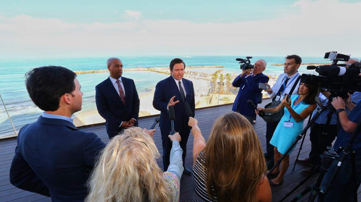 With the Mediterranean Sea as a backdrop, Gov. Ron DeSantis speaks to reporters ahead of the first full day of a Florida trade delegation trip to Israel in June 2019.