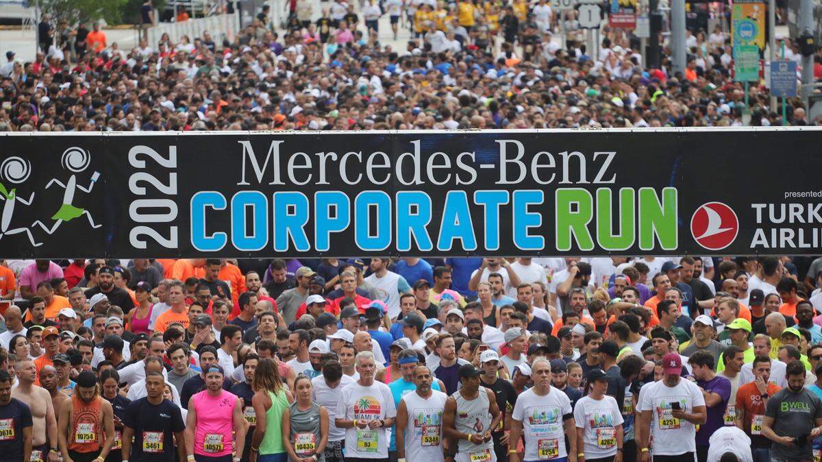 Runners line up at the starting line as the road remains dry while starting the 3.5 mile run under gray skies. More than 9897 runners from 496 companies competed in the Mercedes-Benz Miami Corporate Run, a 3.5-mile team event in which runners/walkers represent their companies or industry-related categories on Thursday, April 28, 2022.