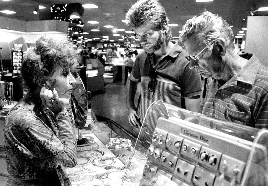 Scene at the Burdines at the Broward Mall as a sales associate helps customers in 1985.
