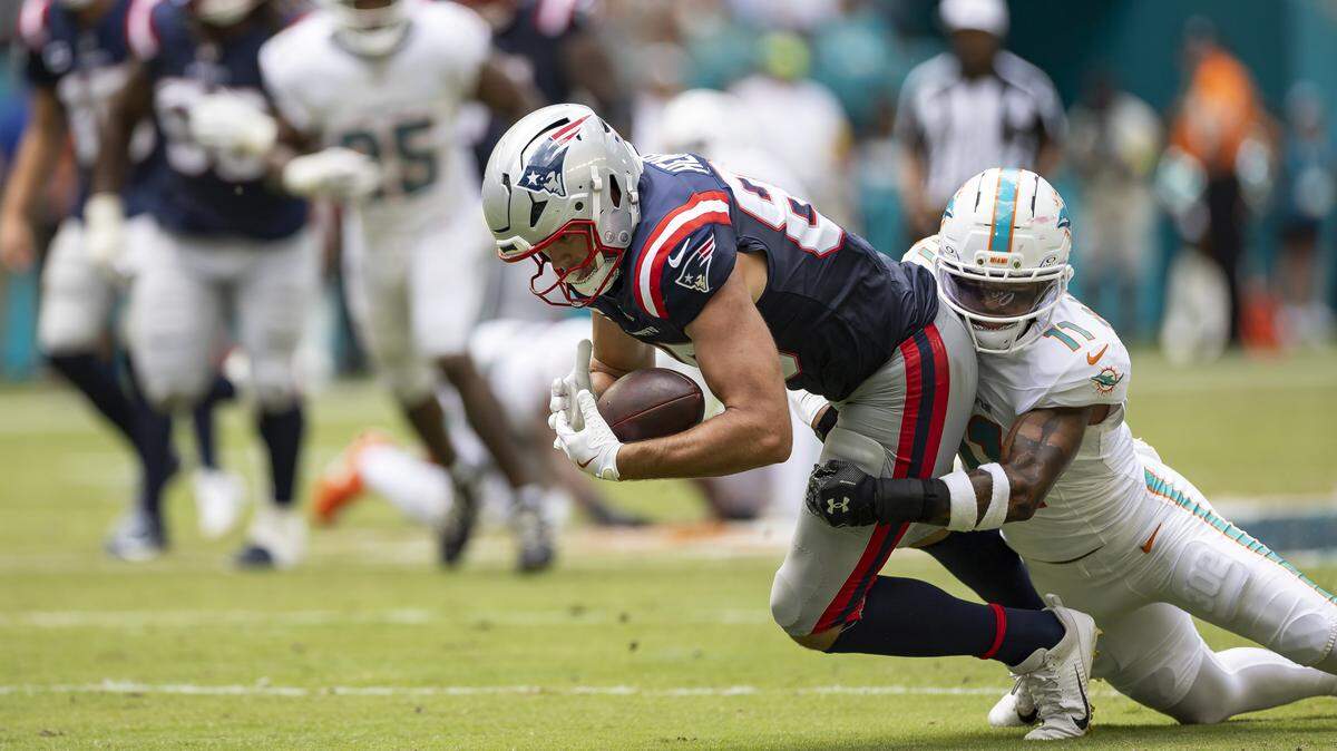 Miami Dolphins linebacker Tyrel Dodson (11) tackles New England Patriots tight end Hunter Henry (85) in the first half of their NFL game at Hard Rock Stadium on Sunday, Sept. 14, 2025, in Miami Gardens, Fla.