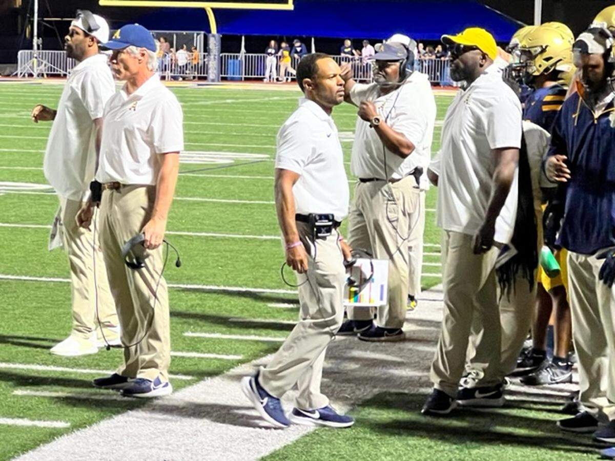 Aquinas coach Roger Harriott (center) improved to 110-11 in his ninth season as the Raiders coach after a 58-0 victory over Dillard on Friday.