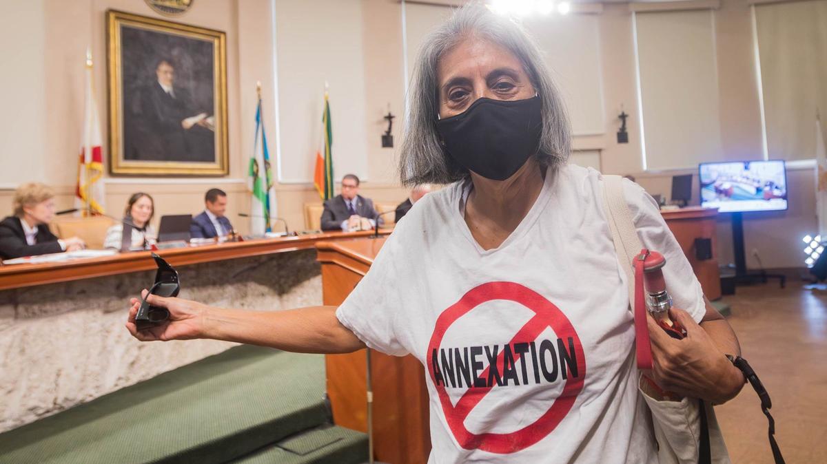 Little Gables resident Gladys Saenz walks out of the Coral Gables City Commission meeting after the city officially ended efforts to annex Little Gables at City Hall on Tuesday, Aug. 27, 2024, in Coral Gables, Florida.