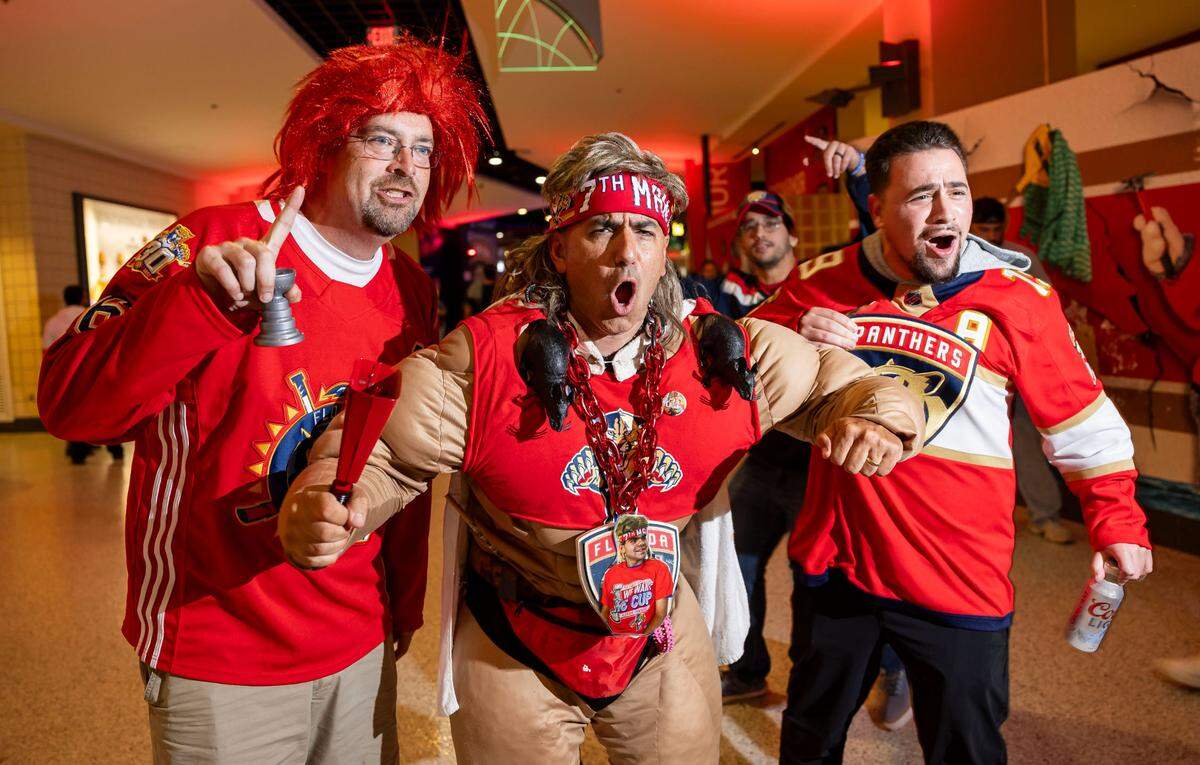 Scott Specter, 44, left, and Rob Veglia, 54, center, react as they attend a watch party at the Amerant Bank Arena to see their team play against the Edmonton Oilers in Game 4 of the NHL Stanley Cup Final
