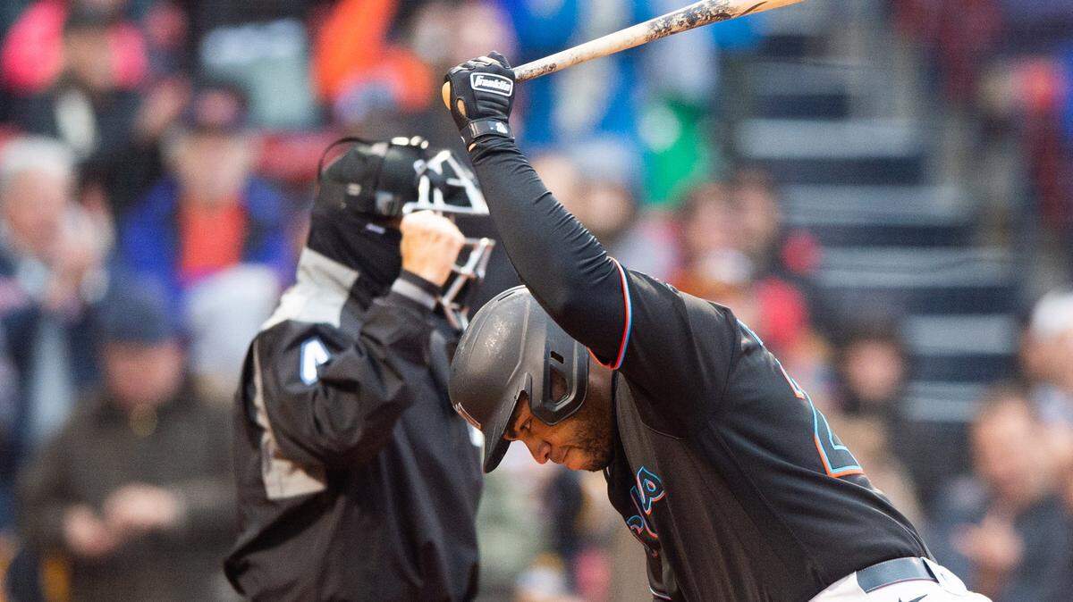 Jesus Aguilar #24 of the Miami Marlins tosses his bat in frustration after striking out in the seventh inning against the Boston Red Sox at Fenway Park on May 29, 2021 in Boston, Massachusetts.