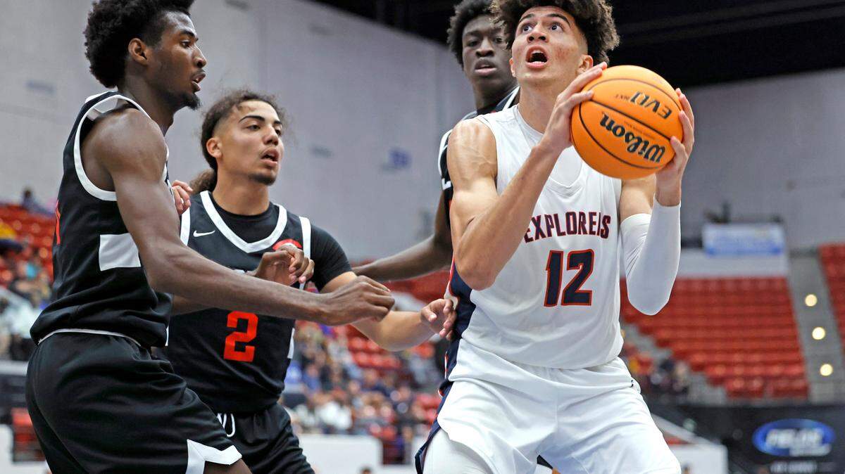 Columbus Explorers Cameron Boozer (12) looks to shoot as Colonial High School players defend in the third quarter during the FHSAA semifinal at the RP Funding Center in Lakeland, Florida on Friday, March 3, 2023.