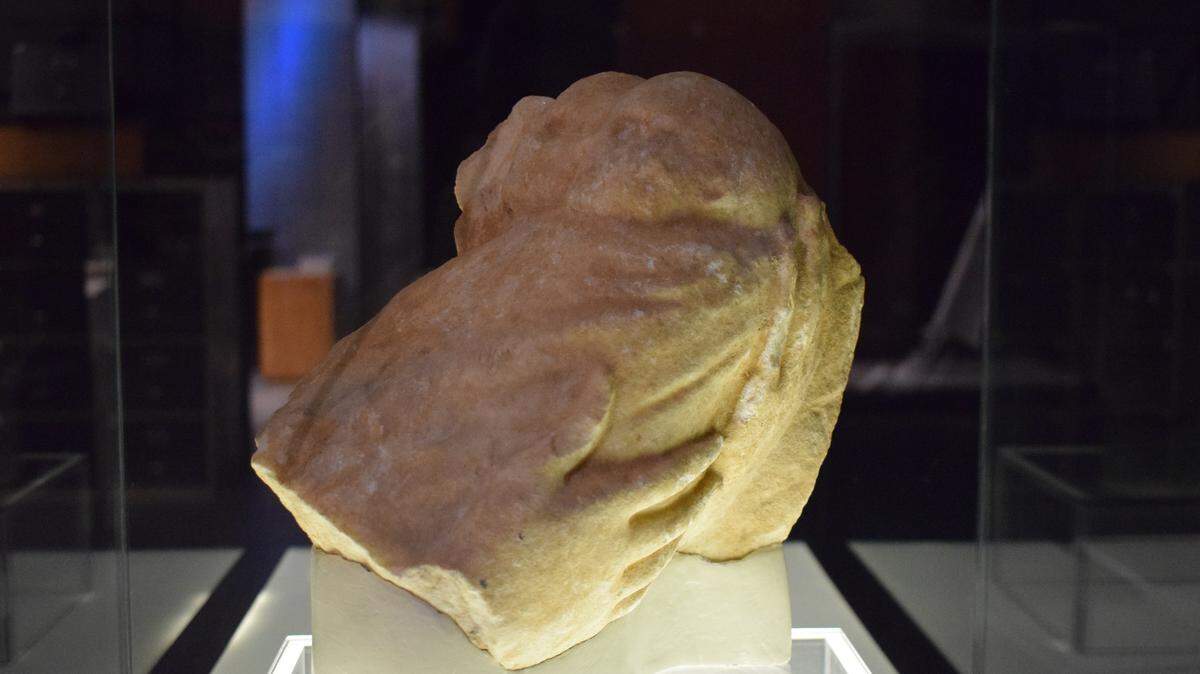 Archaeologists were surprised when a clothed bundle found in a stream held a unique marble carving.