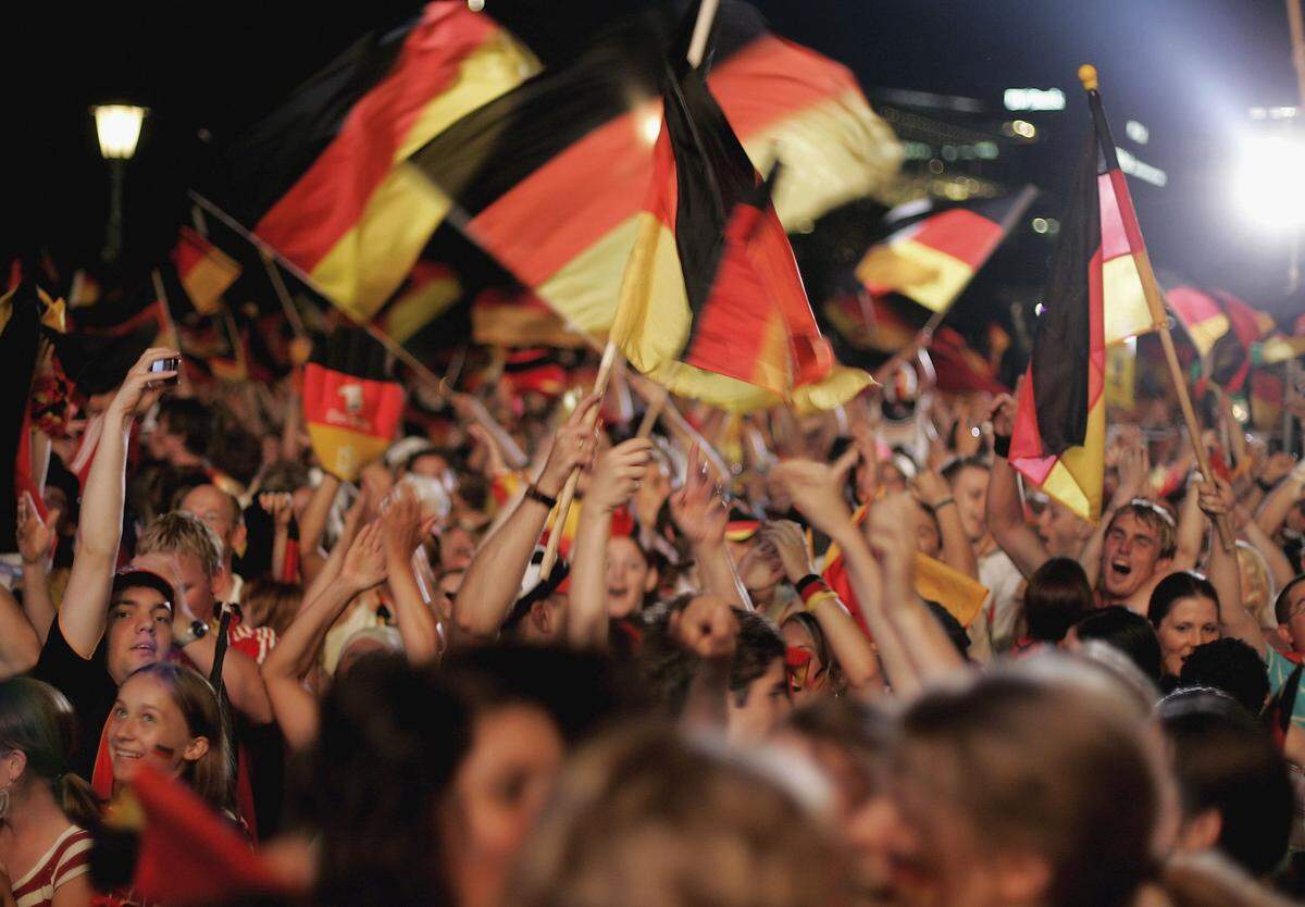 STUTTGART, GERMANY - JULY 08:  German football supporters celebrate a goal of their team at a public viewing area on July 8, 2006 in Stuttgart, Germany. Today Germany plays against Portugal in their FIFA World Cup 2006 third-round play-off football match in Stuttgart.  (Photo by Ralph Orlowski/Getty Images)