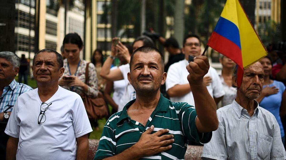 In June 2016, people sing the national anthem in Cali, Colombia, as they celebrate the peace agreement between the government and the FARC leftist guerrilla group.