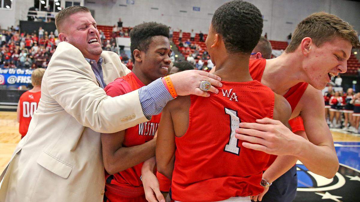Westminster Academy coach Ehren Wellhoff celebrates with his players after defeating Seffner Christian in the 4A Boy’s Finals State Basketball Championships at the RP Funding Center in Lakeland, Florida, Thursday, March, 7, 2019.