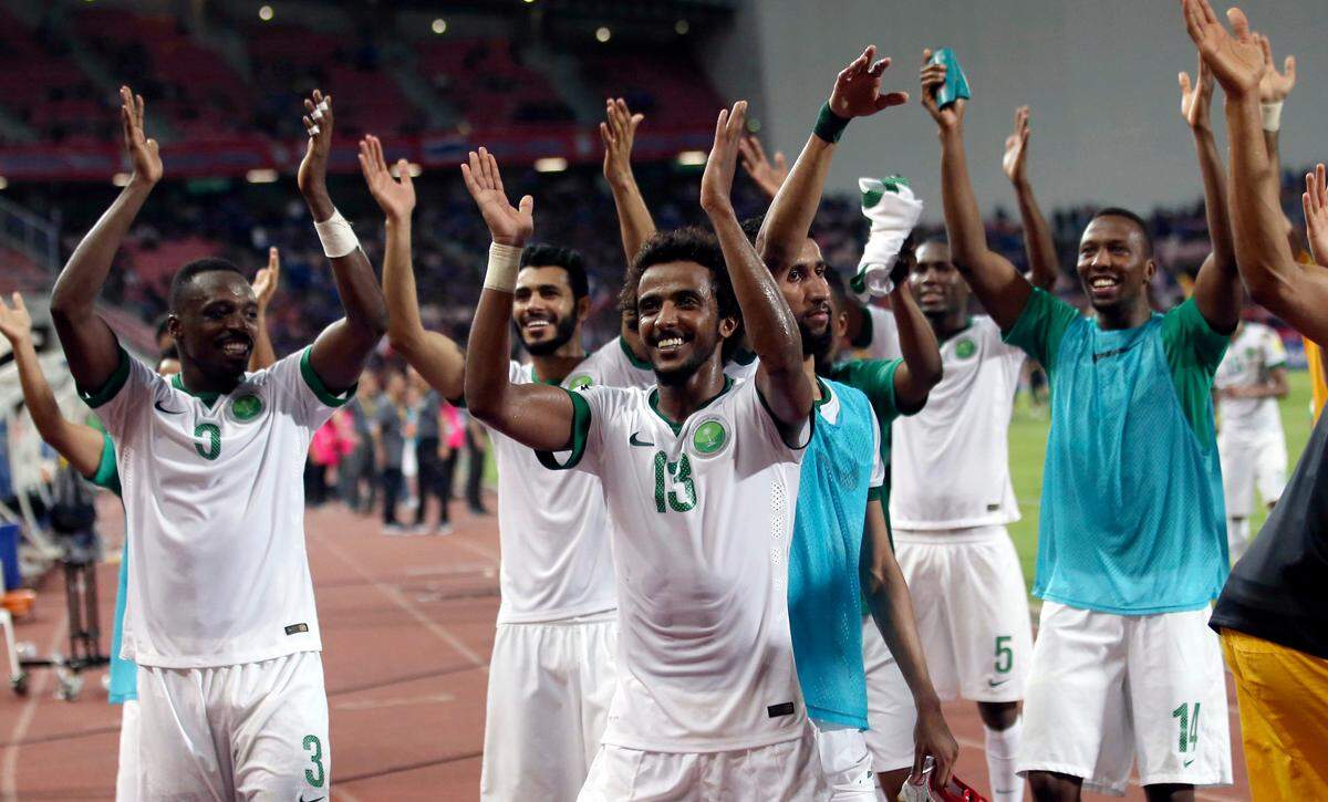 In this Thursday, March 23, 2017, file photo, Saudi Arabia soccer teammates celebrate their 3-0 win in their World Cup qualifiers soccer match against Thailand at Rajamangala national stadium in Bangkok, Thailand.