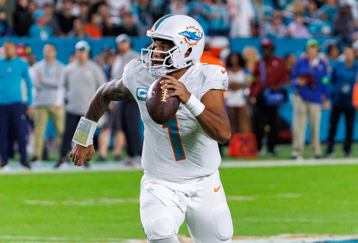 Miami Dolphins quarterback Tua Tagovailoa (1) scrambles for yardage during first half of an NFL football game against the Buffalo Bills at Hard Rock Stadium on Sunday, Jan. 7, 2024 in Miami Gardens, Fl.