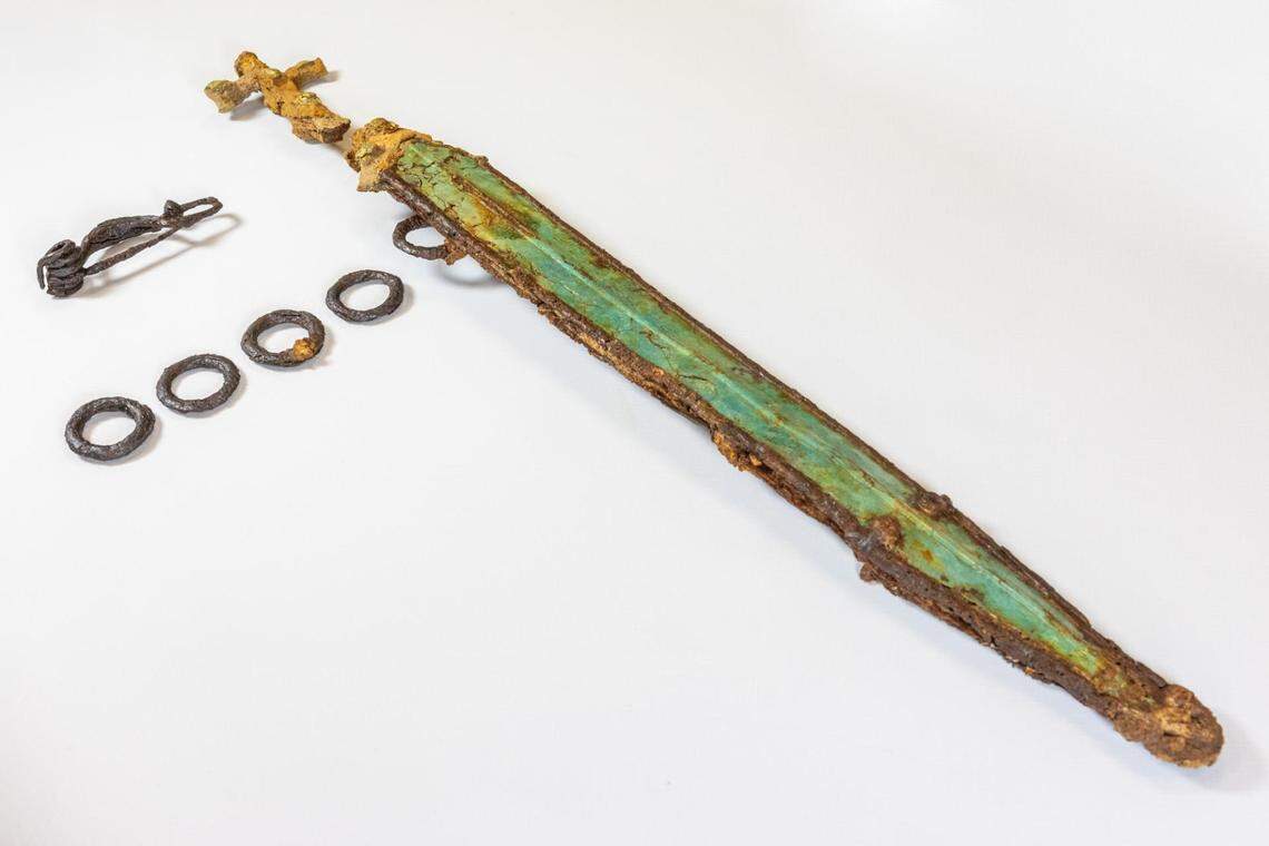 Two swords were discovered, a shorter decorated sword, and a longer sword with rings still attached (pictured).